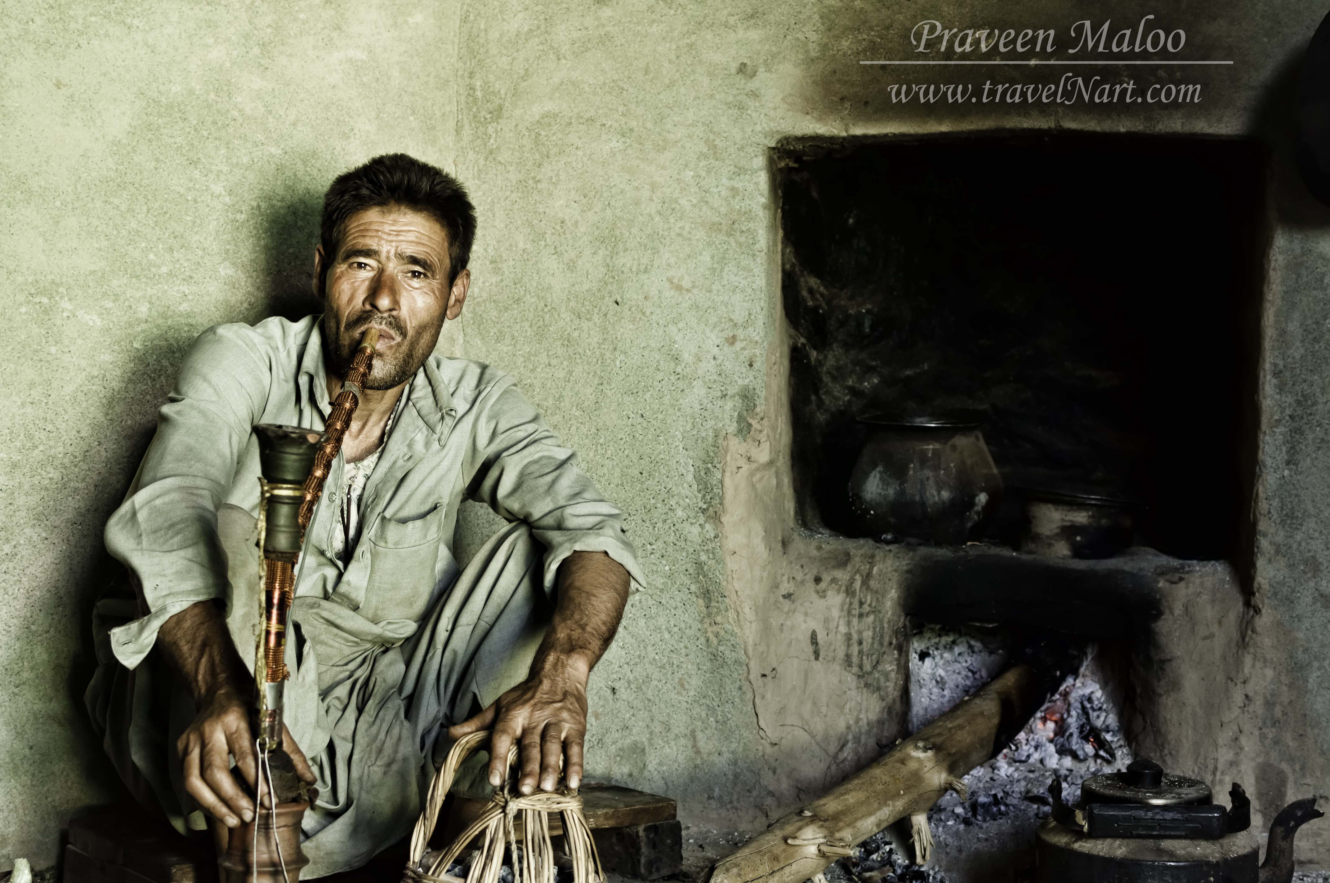 A kashmiri man smoking his Sheisha in a Tourist refuge in Lidderwat, Kashmir, near the Indo-Pak border